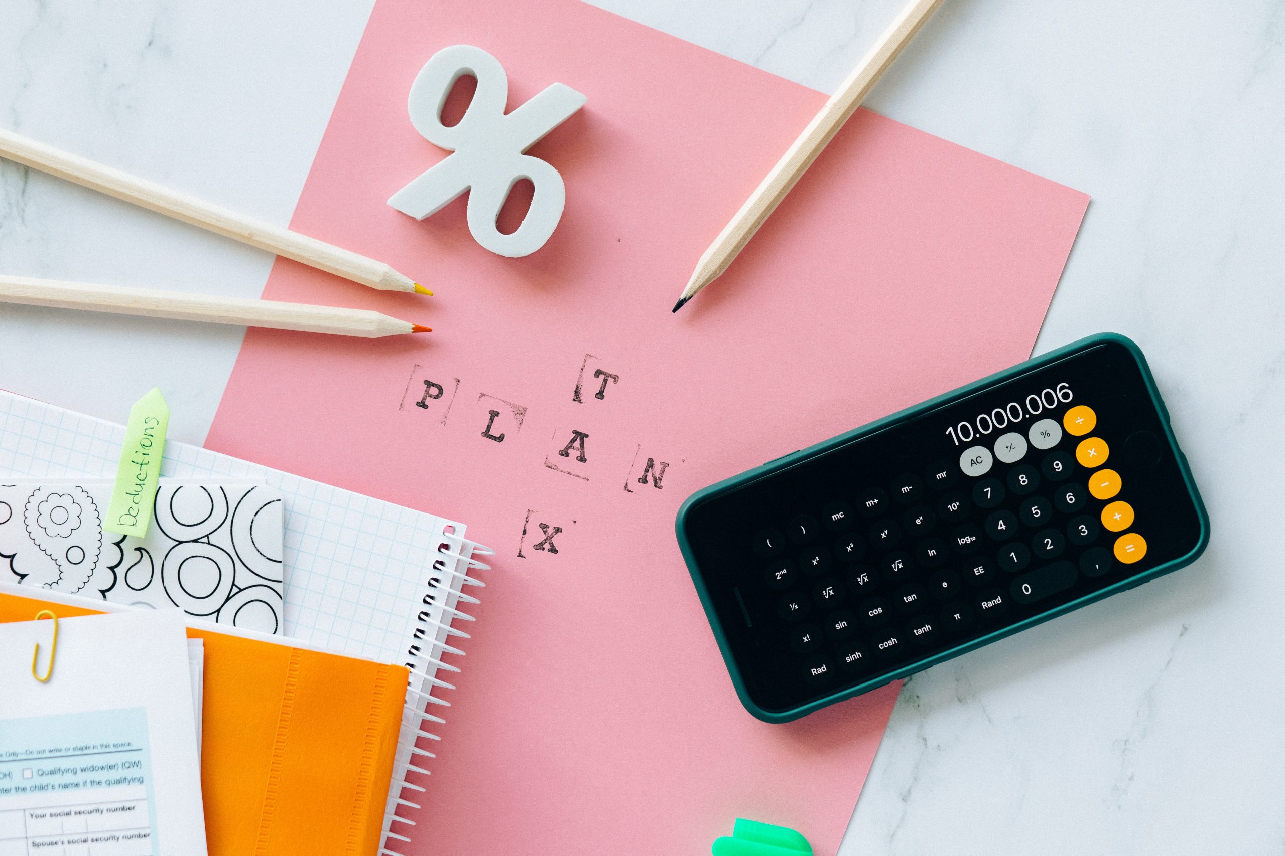 plan tax written besides a calculator. showing how bitcoin tax in canada is caculated