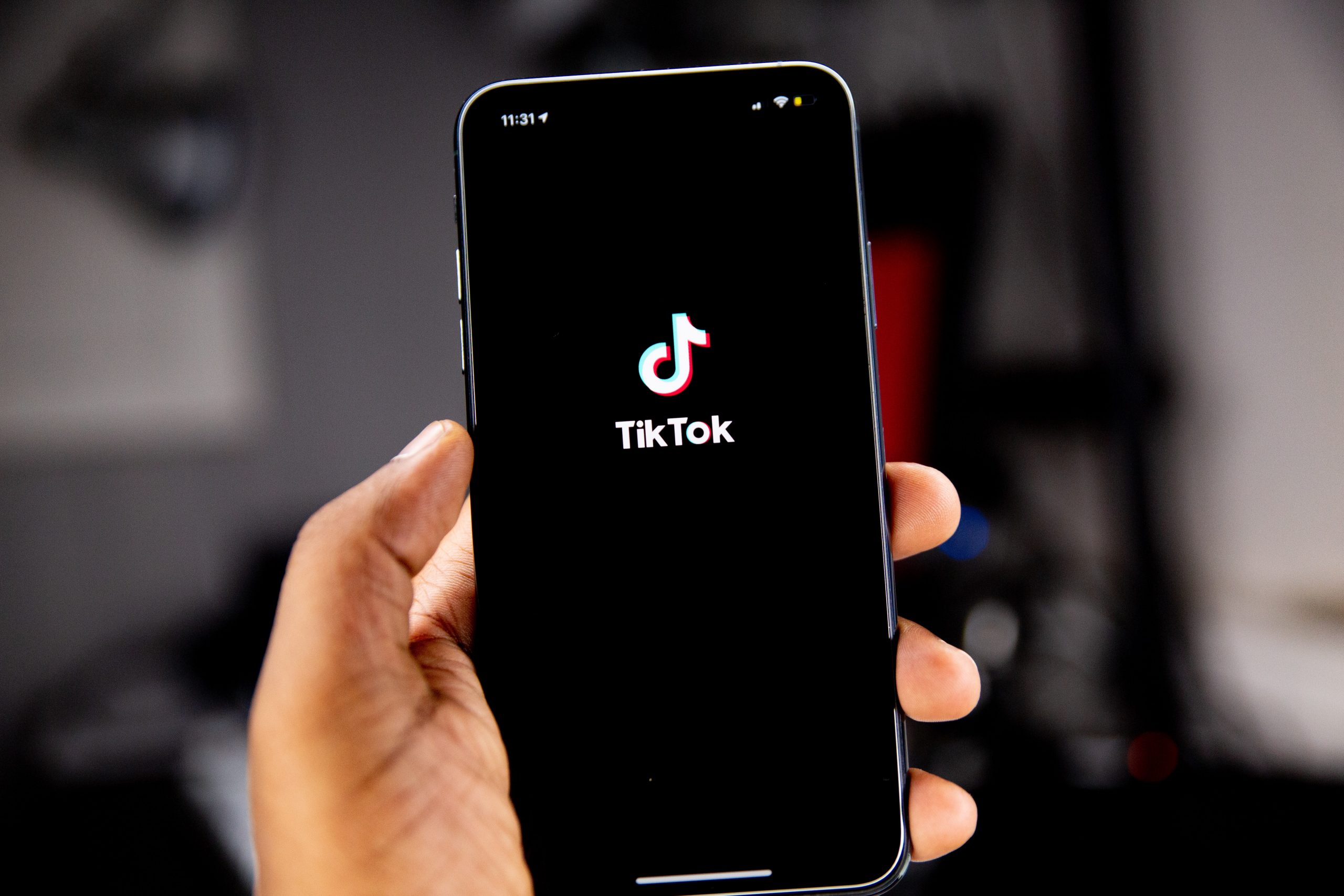 A person holding a phone with TikTok open